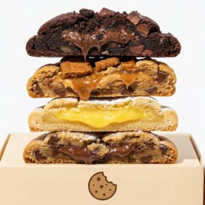 Artisan cookie gift box open showing 6 assorted homemade cookies in rustic elegant packaging on linen